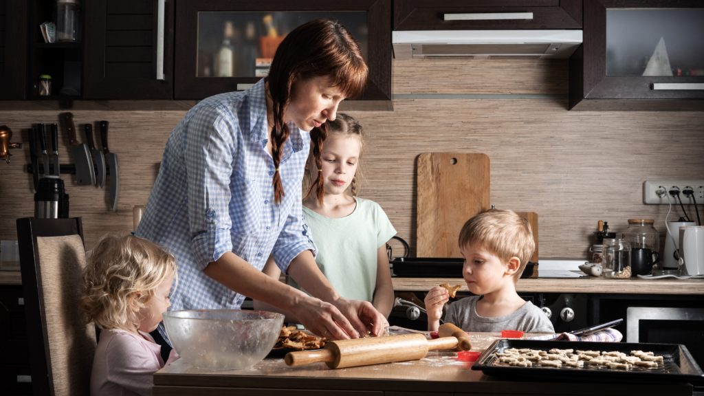 mom and kids cooking in kitchen