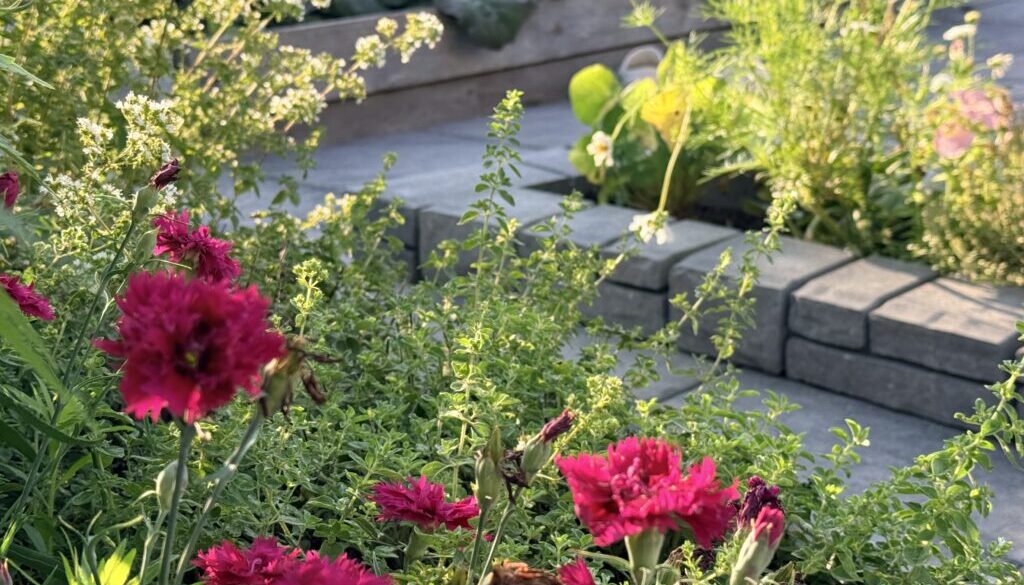 Companion planting flowers and herbs among vegetable garden beds